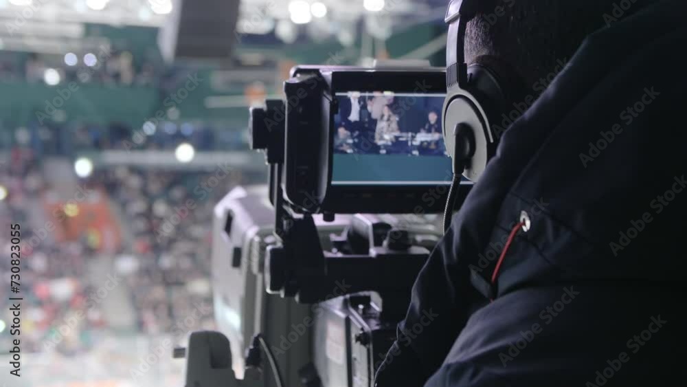 Professional operator adjusts focus to ensure crystal clear in footage. Operator maneuvers camera to follow fast-paced movements of players Professional operator adjusts focus to ensure crystal clear in footage. Operator maneuvers camera to follow fast-paced movements of players