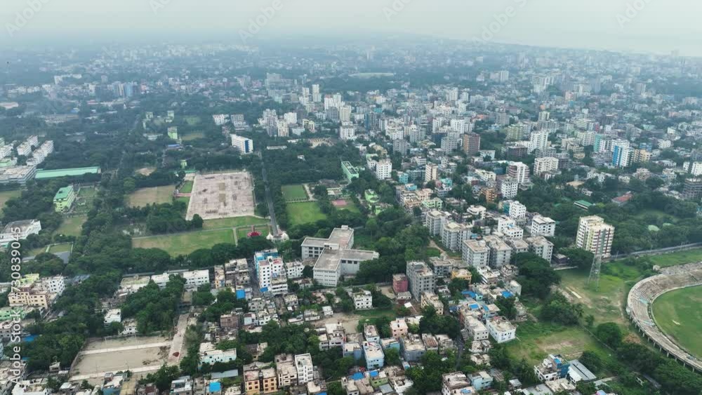 Aerial perspective of Rajshahi city in Bangladesh, nestled by the serene banks of the Padma River. Marvel at its vibrant urban landscape, rich heritage in this captivating drone footage. 4k Aerial perspective of Rajshahi city in Bangladesh, nestled by the serene banks of the Padma River. Marvel at its vibrant urban landscape, rich heritage in this captivating drone footage. 4k