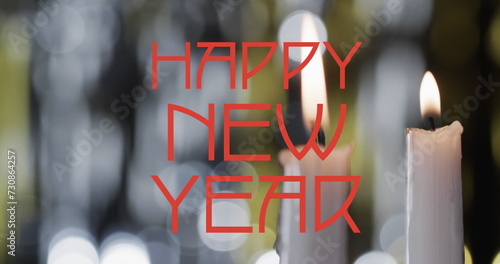 Image of happy new year text over lit candles background