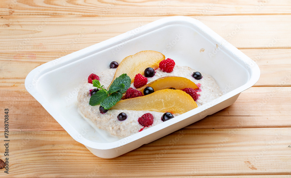 Stewed pear with curd mousse. Healthy food. Takeaway food. On a wooden background. Stewed pear with curd mousse. Healthy food. Takeaway food. On a wooden background.
