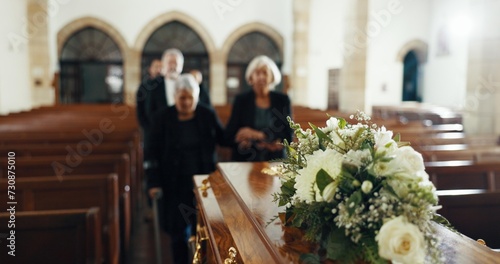 Funeral, church and people with coffin for goodbye, mourning and grief in memorial service. Depression, family and sad senior women with casket in chapel for greeting, loss and burial for death photo