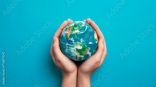Hands cradling Earth globe on blue background, concept of global care and environmental protection, isolated.
