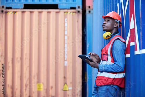 factory worker or engineer working on tablet in containers warehouse storage