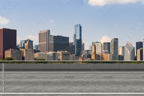 Empty urban asphalt road exterior with city buildings background. New modern highway concrete construction. Concept of way to success. Transportation logistic industry fast delivery. Chicago. USA.