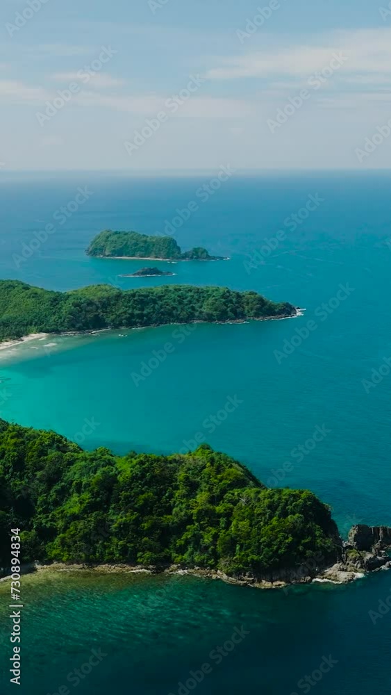 Tropical Island with blue sea. Blue sky and clouds. El Nido, Palawan. Philippines. Vertical view. Tropical Island with blue sea. Blue sky and clouds. El Nido, Palawan. Philippines. Vertical view.