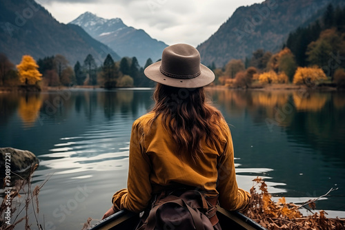 Girl in a canoe on a lake with an autumn background © Beatriz