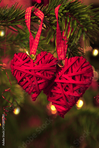 Valentine's Day background with two hanging heart shapes on Christmas tree.