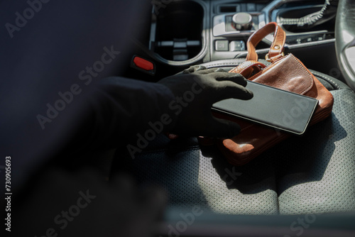 Thief stealing a purse and telephone.