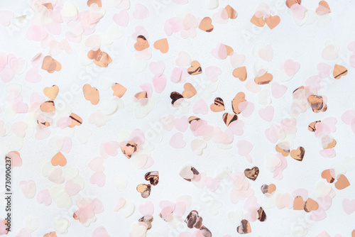Pink and golden hearts on white table top view, Romantic valentines background photo
