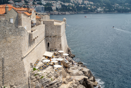 One of the romantic cafes outside the city walls of Dubrovnik, where you can enjoy a beautiful view of high cliffs and endless blue sea.