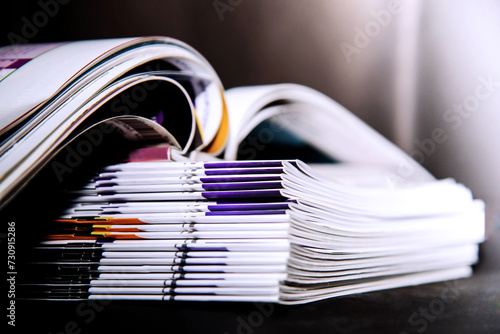 Stack of magazines on black background, isolated in university library Education concept