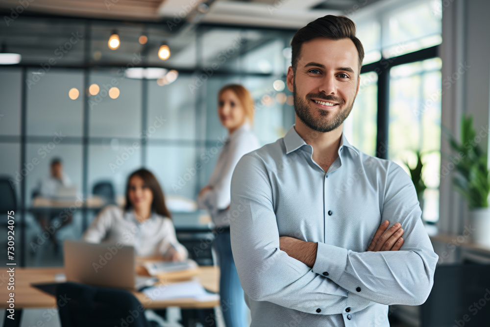 A portrait of a cheerful businessman standing in a conference room with his arms crossed. A portrait of a cheerful businessman standing in a conference room with his arms crossed.