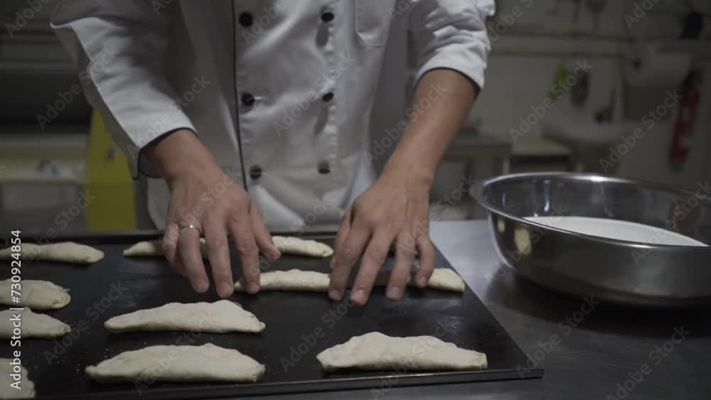 Pastry chef finishes sweet by dipping it in sugar Pastry chef finishes sweet by dipping it in sugar