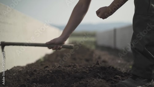Farmer sowing seeds in soil fertilized by worms photo