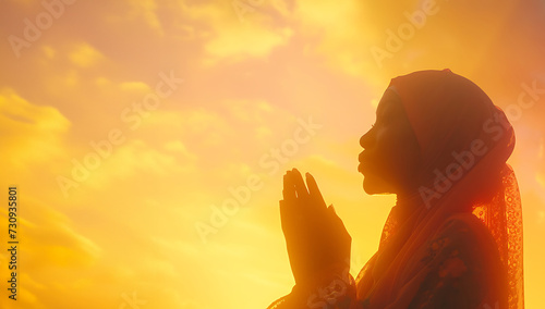 Muslim woman is praying against the sky