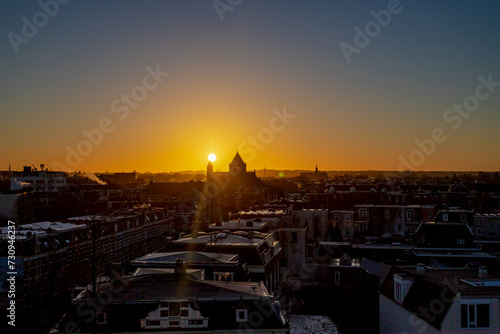 Winter cityscape with architecture traditional and moden houses, The sun rising above city with warn sunlight sky in morning, The Dutch province of Gelderland on the Waal river, Nijmegen, Netherlands.