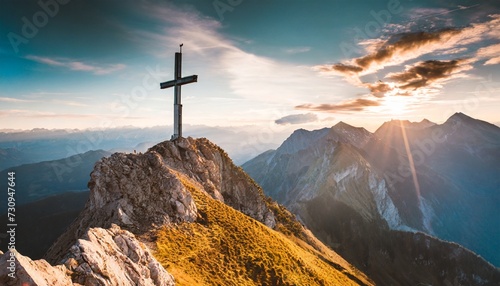 mountain summit cross on alpine peak at sunset