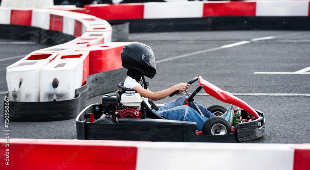 Small Girl Rides On A Kart On A Race Track, Enjoying Extreme Entertainment