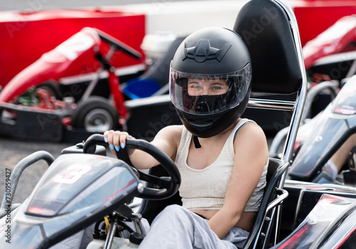 Portrait Of Young Girl In Protective Helmet In Racing Karting On A Track