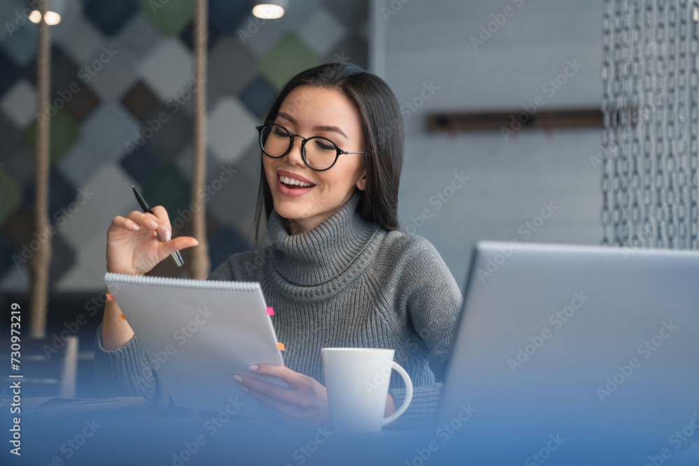 Close up shot of young attractive businesswoman that reading document with smile and pen in her hand. Paperwork, documents, payments, billing, license - obrazy, fototapety, plakaty 