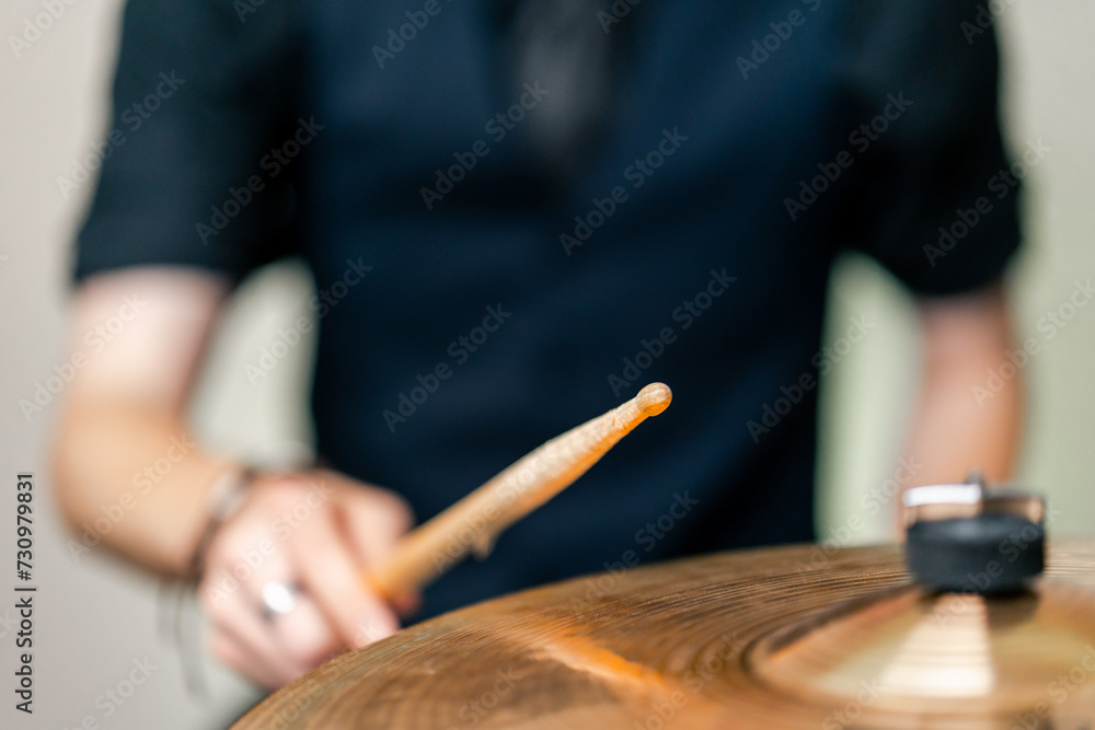 close-up musician during rehearsal plays drums musical instrument drumsticks music concert