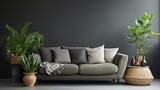 Sofa with pillows in front of gray wall, pots of green plants are behind.