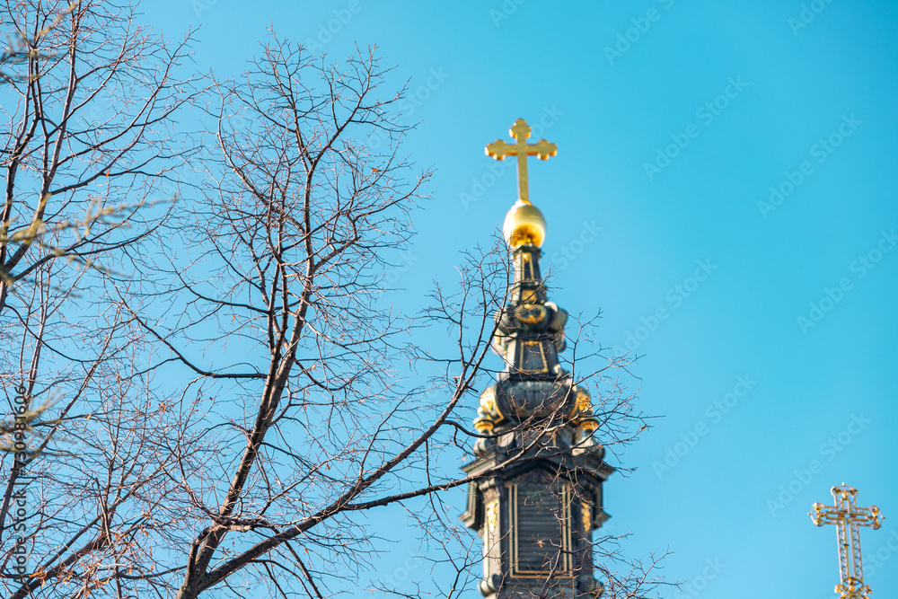 majestic architecture of Novi Sad's iconic church, its blue hues contrasting against the golden dome and cross, symbolizing the rich history and religious heritage of Serbia.