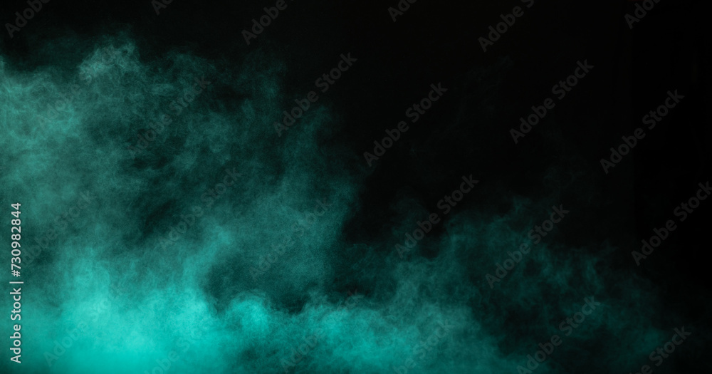 Obraz premium Blue powder dust smoke on black background