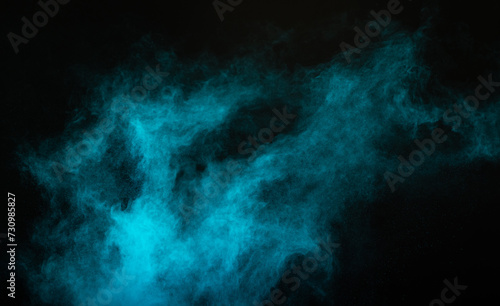 Blue powder dust smoke on black background