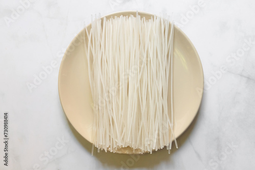 Dried uncooked rice noodles. Kuzukiri vermicelli is made from potato starch on dish.