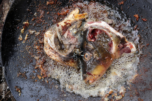 Fried fish heads. Food preparation. photo