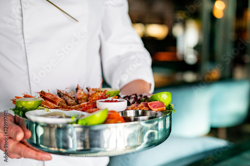 chef hold Set Mixed Seafood on plate