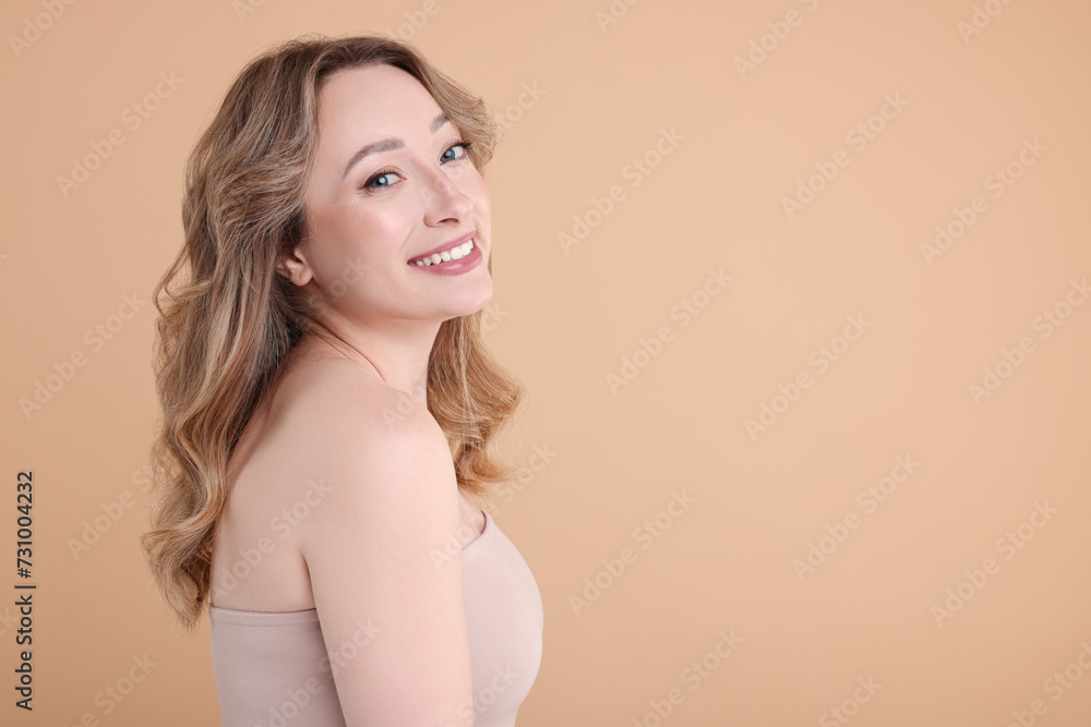 Portrait of smiling woman on beige background. Space for text Portrait of smiling woman on beige background. Space for text