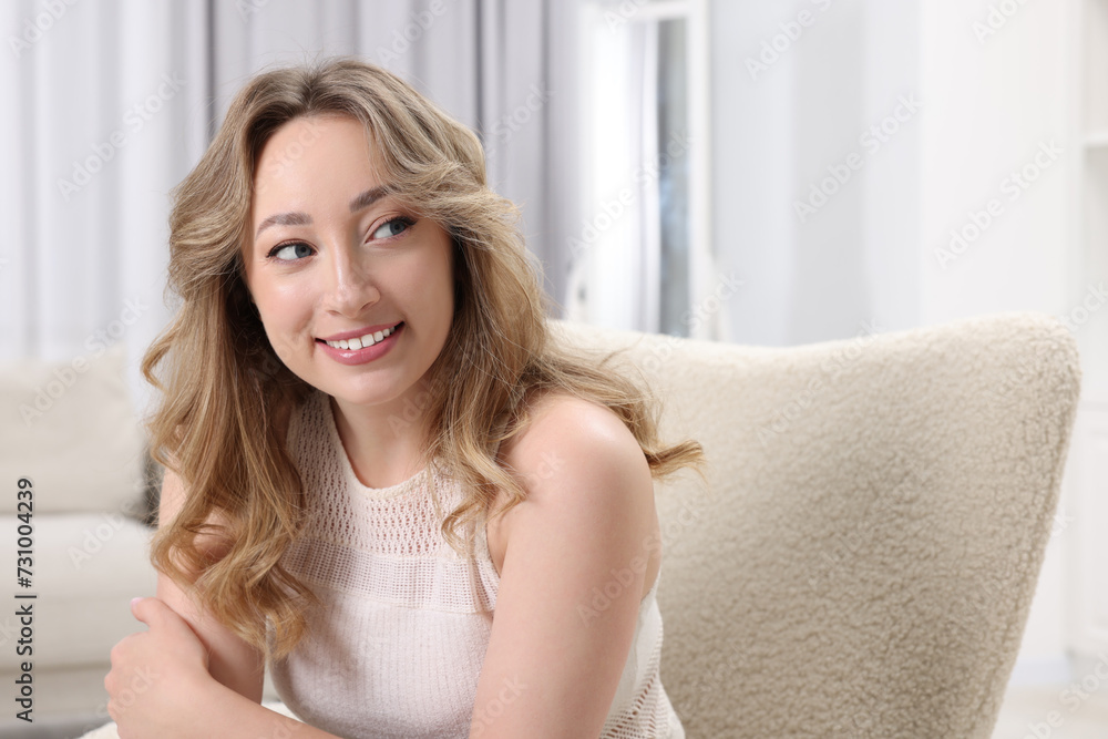 Portrait of smiling woman with curly hair at home. Space for text Portrait of smiling woman with curly hair at home. Space for text