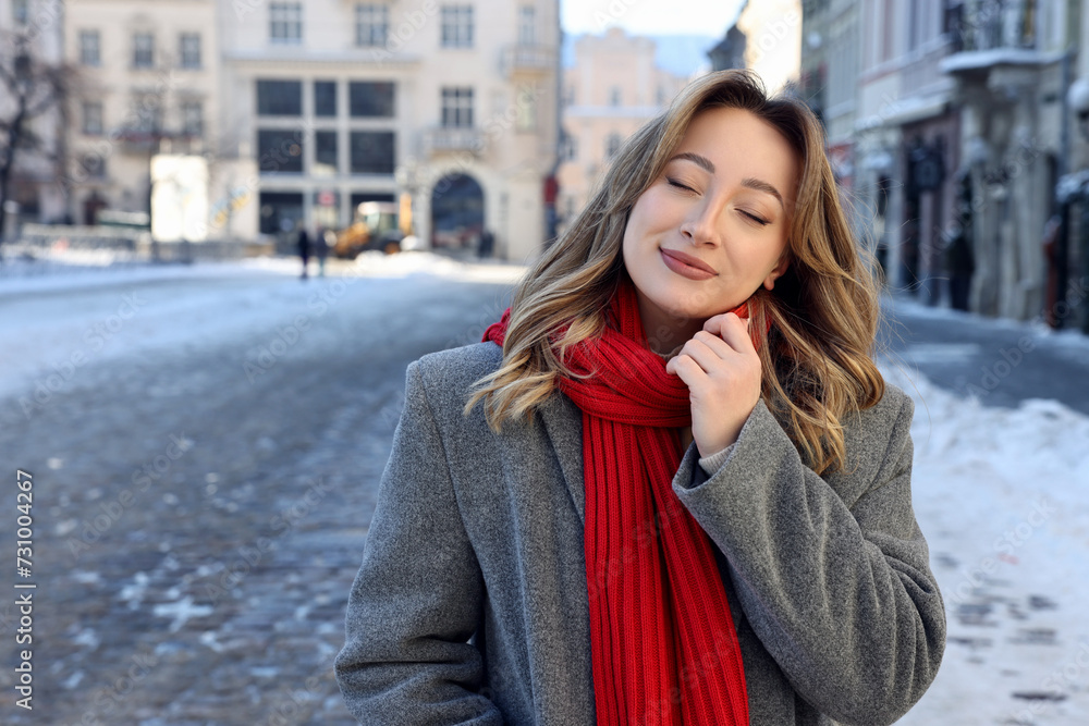 Portrait of charming woman on city street in winter. Space for text Portrait of charming woman on city street in winter. Space for text