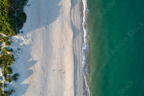 drone aerial zenithal view of a beach at dawn