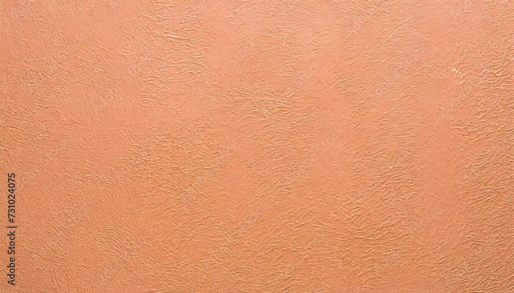 Fototapeta premium Background of embossed texture in peach fuzz color.
