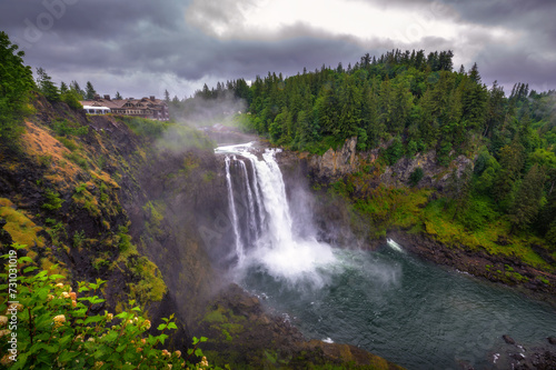 Snoqualmie Falls with lush greenery and mist in Washington State, USA. Snoqualmie Falls is a 268-foot waterfall on the Snoqualmie River between Snoqualmie and Fall City.