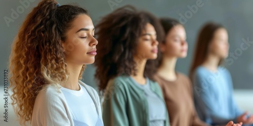 Group of young women sitting and meditating © xartproduction