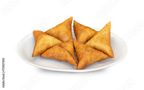 Vegetable samosas on white background  Spicy indian or Pakistani snacks. street food on white plate 