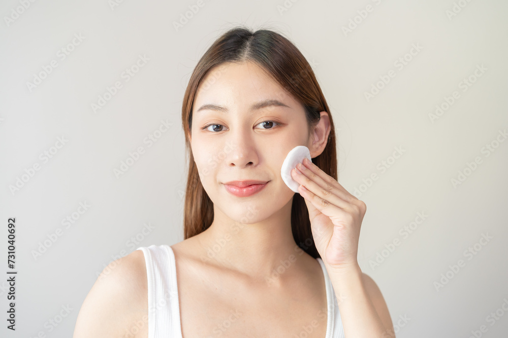Close-up view woman using toner and cotton pad to remove makeup Close-up view woman using toner and cotton pad to remove makeup