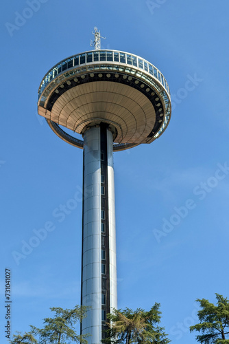 A former transmission tower with an elevator and observation deck. Tall observation tower in the shape of a plate against the blue sky