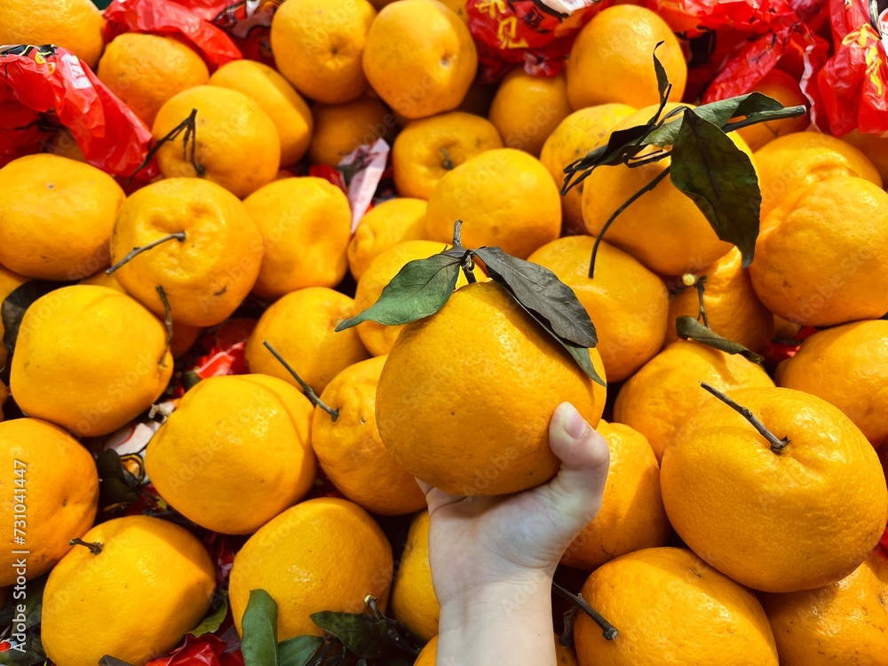 Kids hand holding some oranges at market