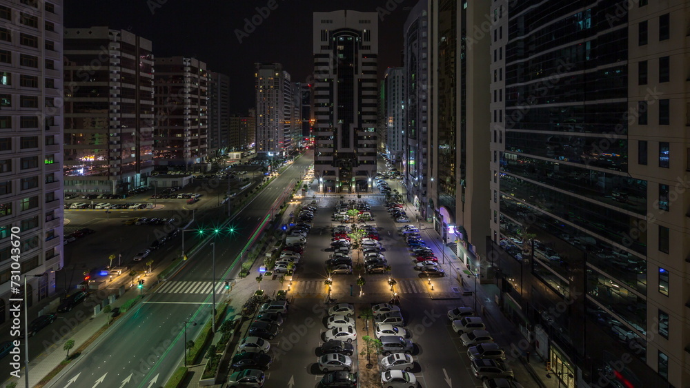 Residential buildings and modern city architecture of Abu Dhabi aerial timelapse during all night, UAE.