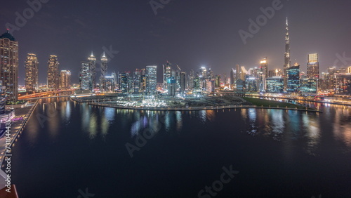 Aerial panorama of Dubai Business Bay and Downtown with the various skyscrapers and towers day to night timelapse © neiezhmakov