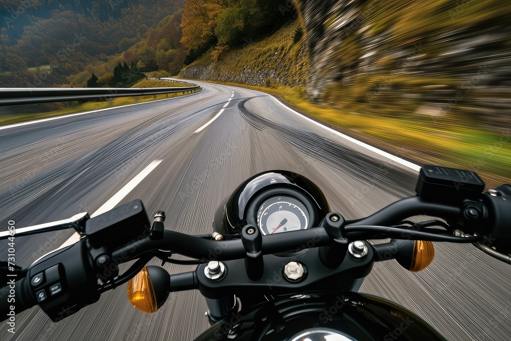 A black motorcycle speeding down a winding road. A black motorcycle speeding down a winding road.