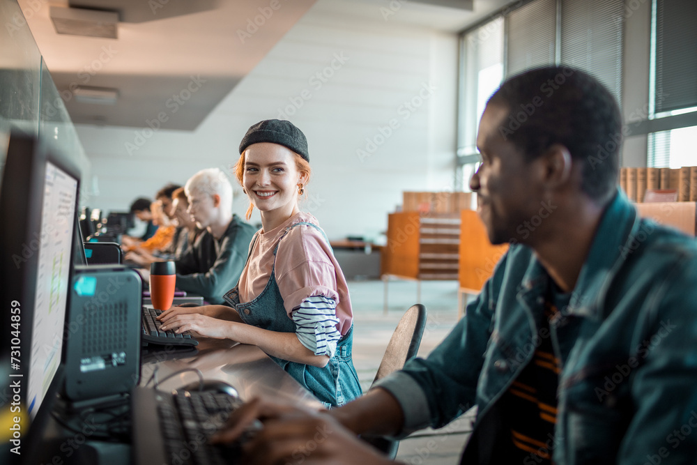© Marko Geber - Diverse young students using computer in university lab
