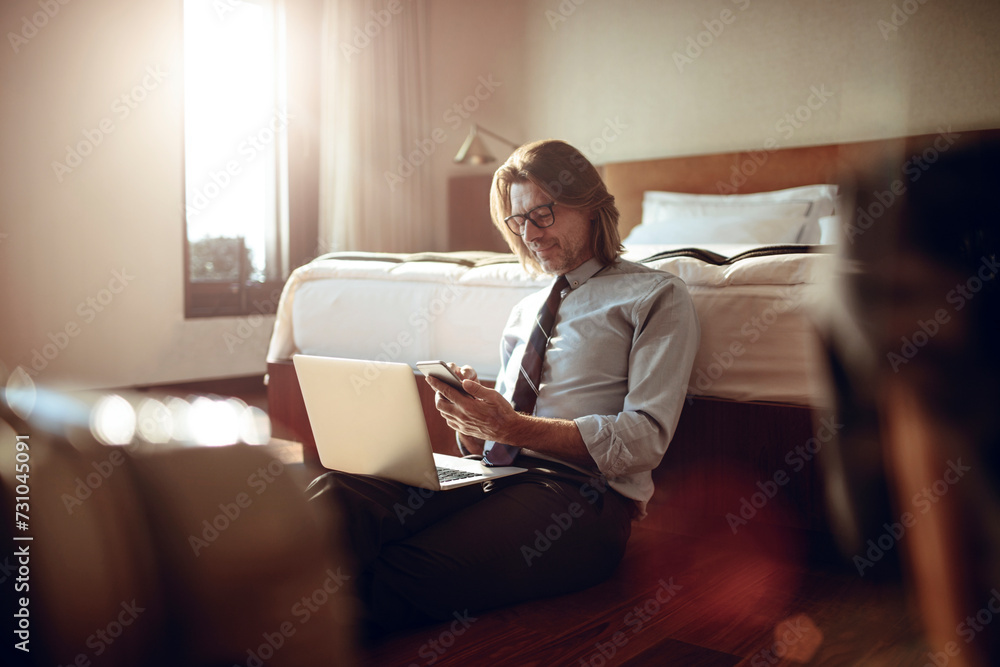 Businessman using smartphone in hotel room Businessman using smartphone in hotel room