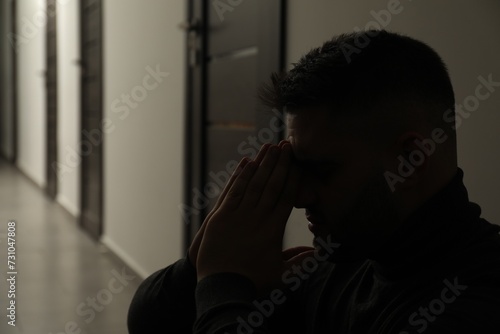 Silhouette of sad man in hall. Space for text