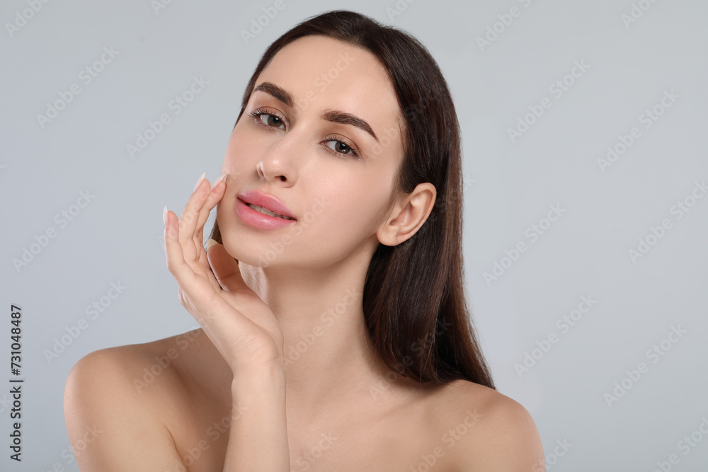 Portrait of beautiful young woman on light grey background Portrait of beautiful young woman on light grey background